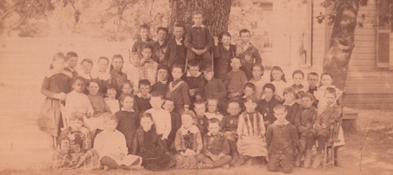 Irene Veasey, second row, far left, in a class photo, possibly of a school in St. Helena, ca. 1885