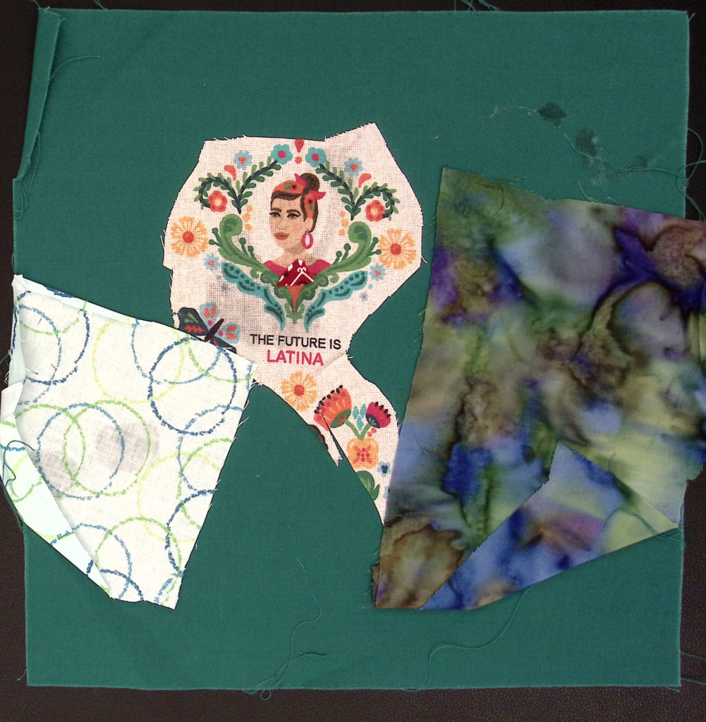 A dark green square with two patches of patterned cloth, in the middle a woman and the text "the future is Latina."