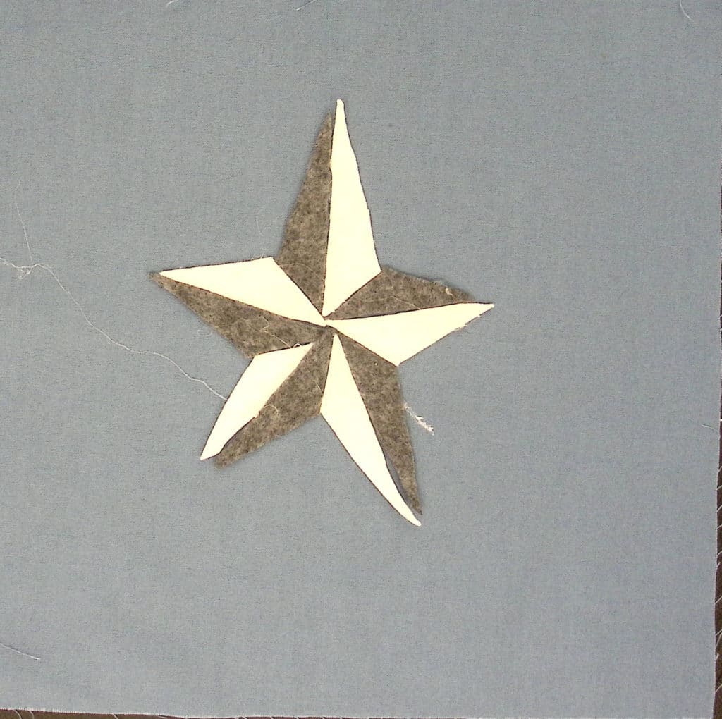 A blue-gray background with a white and gray five pointed star.