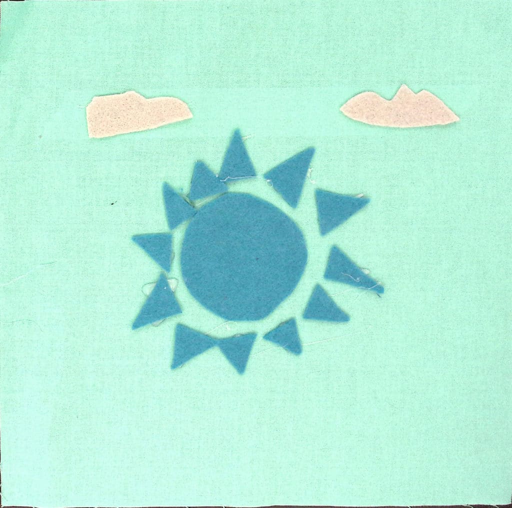 Light blue background with a darker blue sun and small gray clouds.