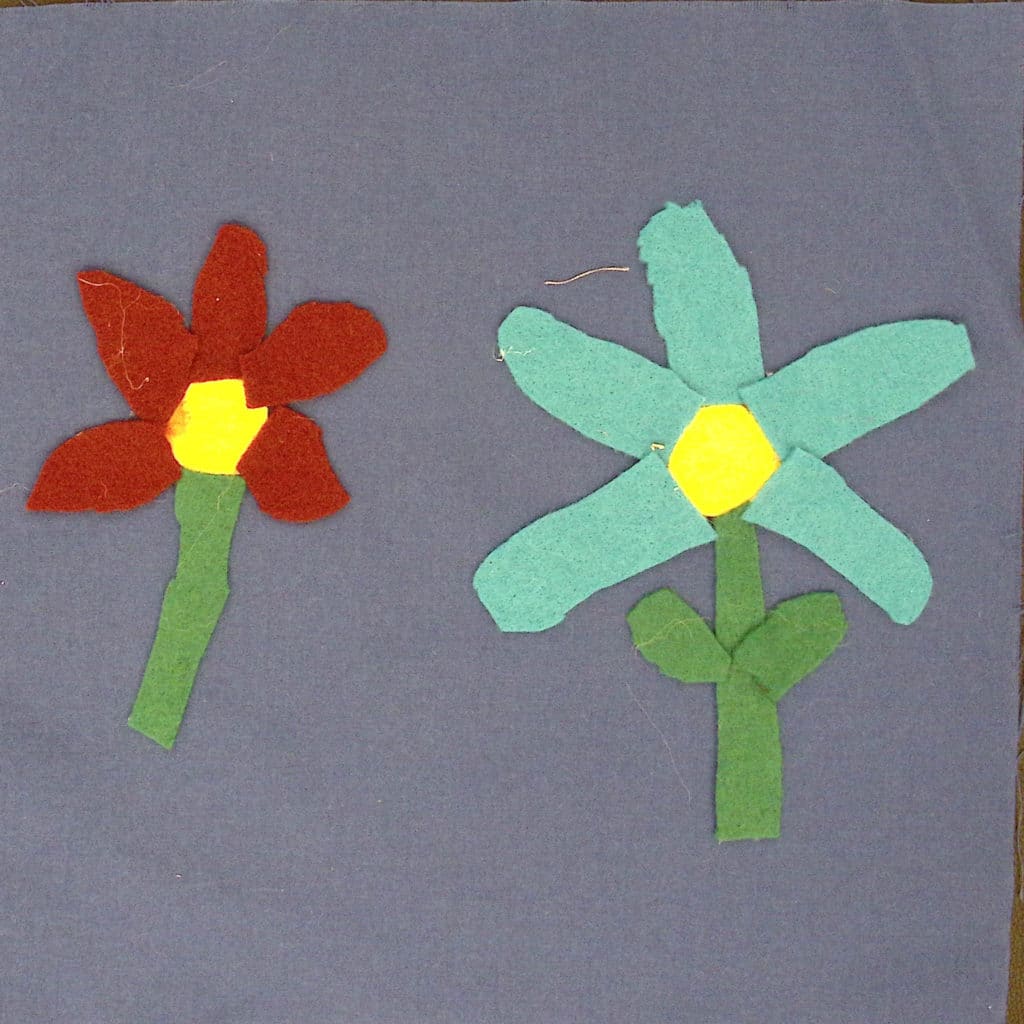 A red and blue flower with yellow centers on a blue background.