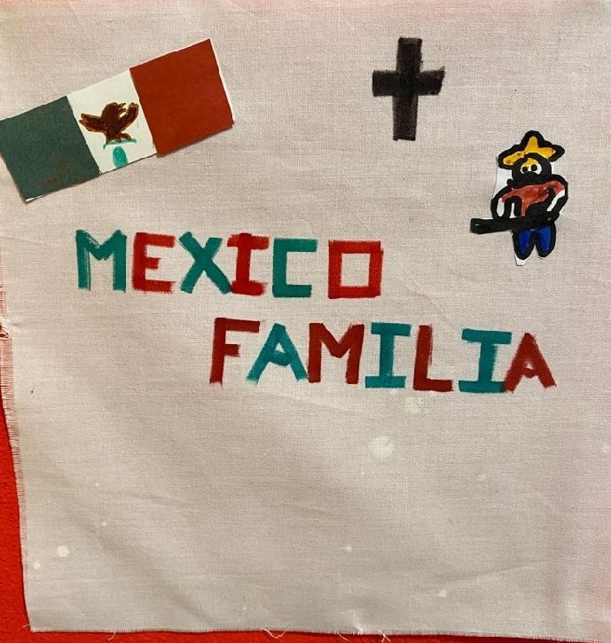 A white square with the words "Mexico familia," the Mexican flag, a cross, and a little man with a guitar.