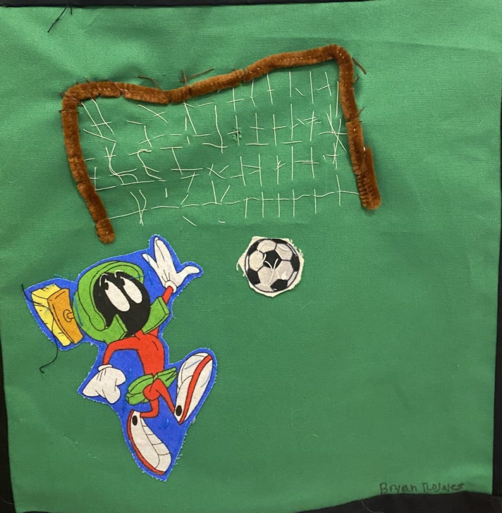 Cartoon character Marvin the Martian playing soccer with a ball and goal net.