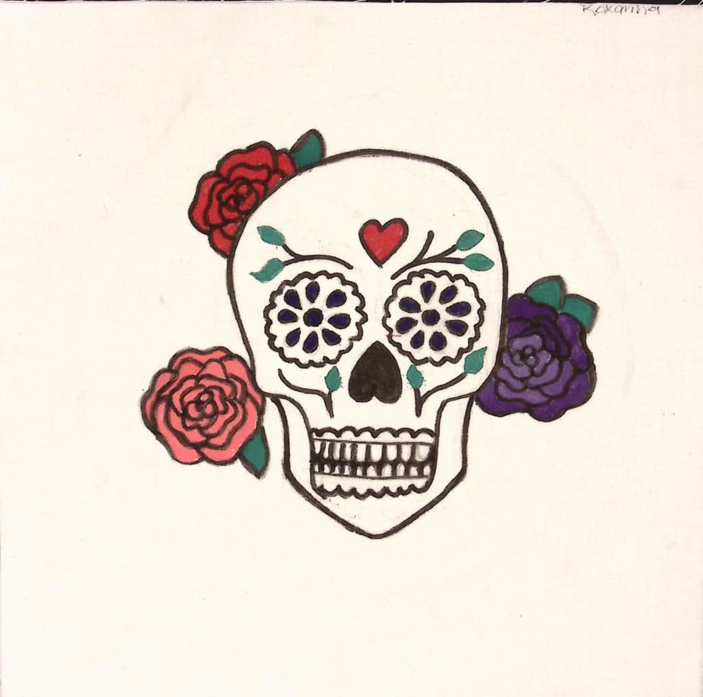 A calavera with pink, red, and purple roses and a heart on the forehead.