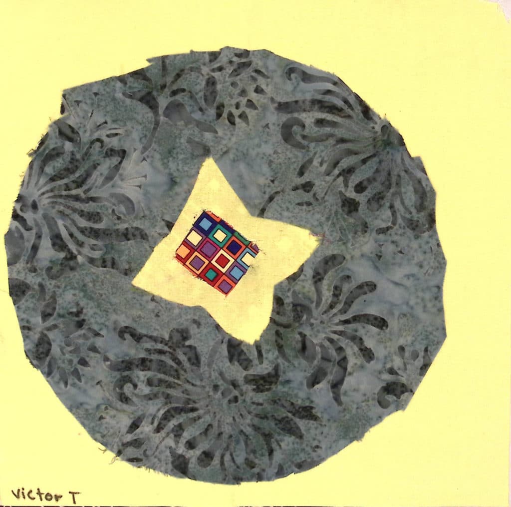 A gray patterned circle on a yellow background, with a yellow star in the center with multicolored fabric.