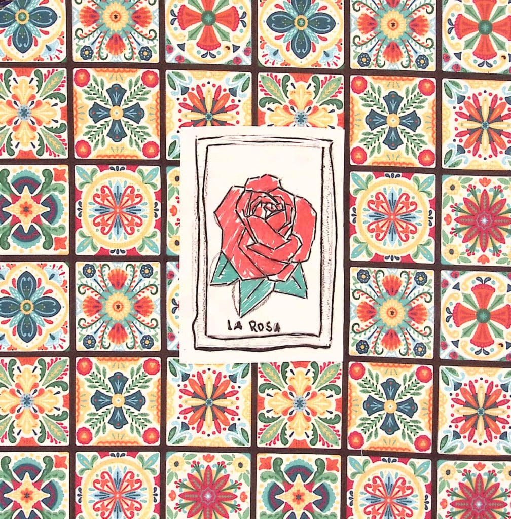 A card with a red rose titled "La Rosa" on a multicolored background