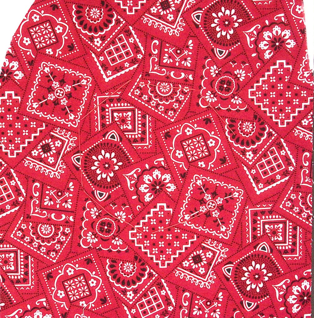 A red bandana-patterned fabric with red stitching.
