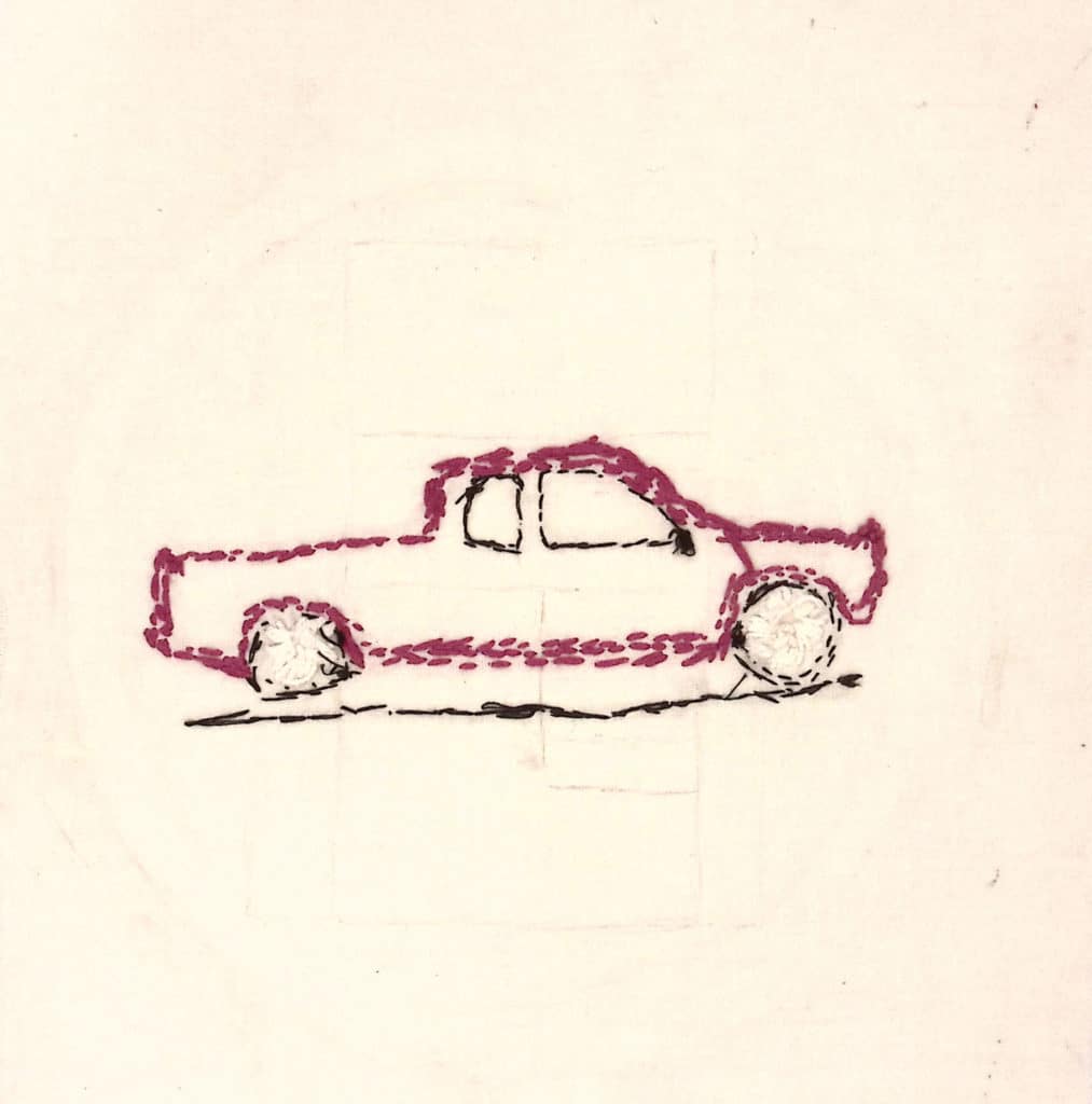 A purple car or small truck embroidered on white background.
