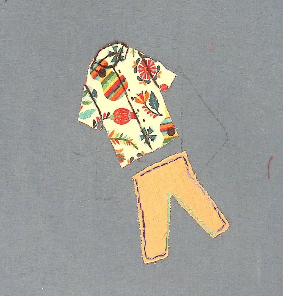 A fabric, floral shirt and pants on a blue background