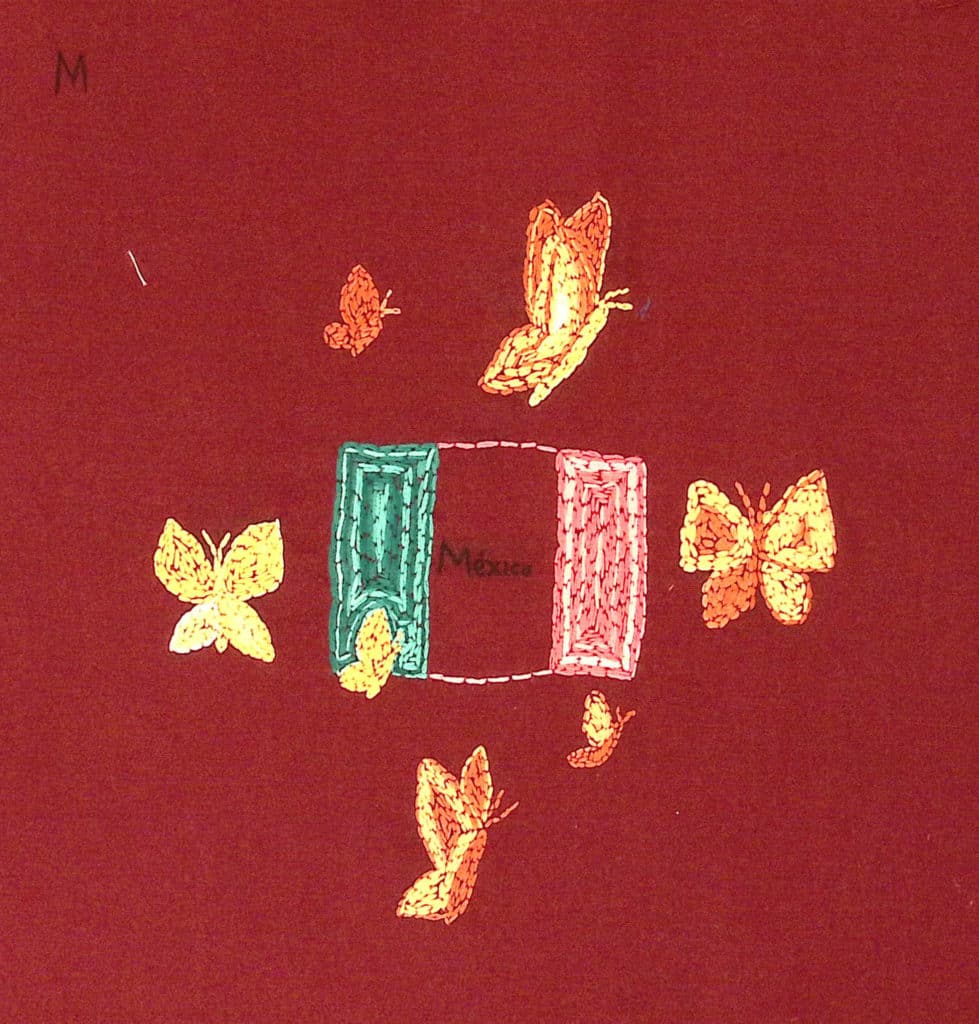 An embroidered Mexican flag with orange butterflies on a red background