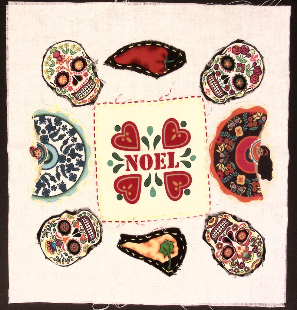 White square with "Noel" in the center, surrounded by small hearts, four skulls, two dancers, and two chilis
