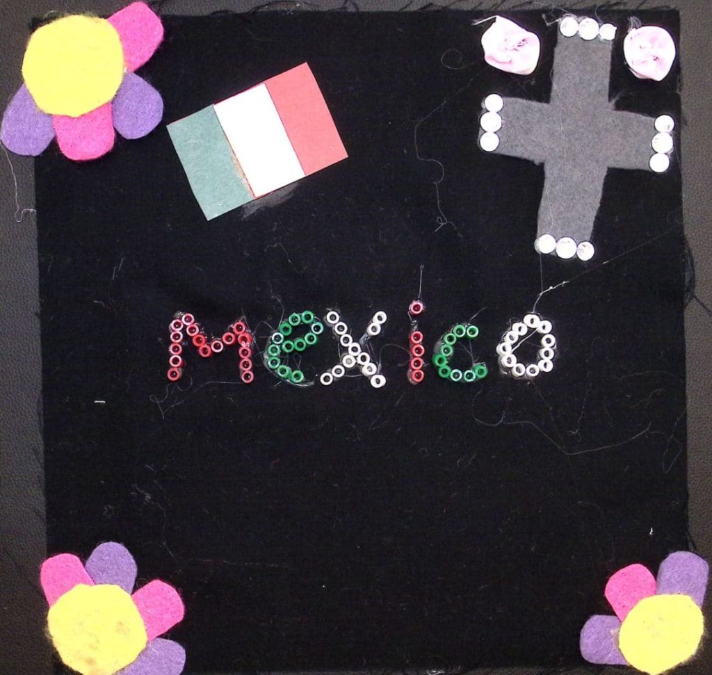 A black square with pink and purple flowers, a Mexican flag, a cross, and the word Mexico written in green, white and red perler beads