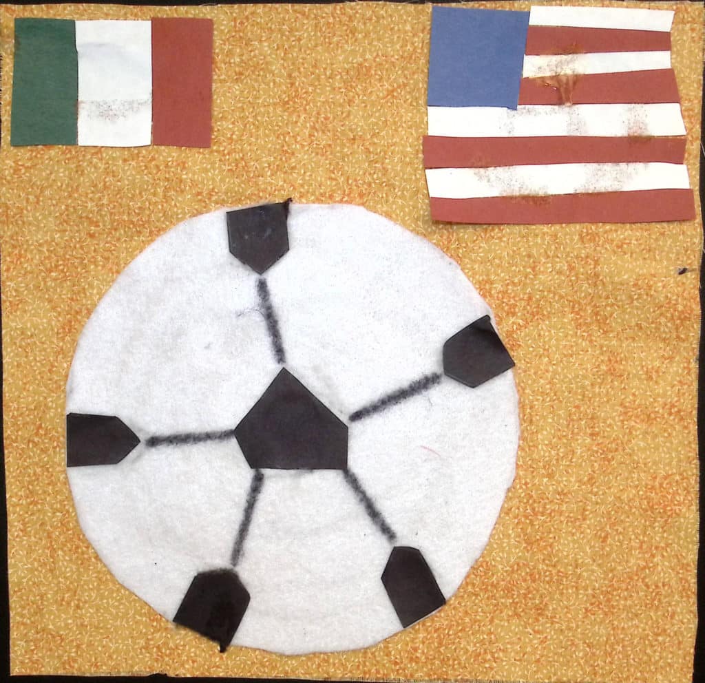 A soccer ball with an Italian flag in one corner and an American flag in the other