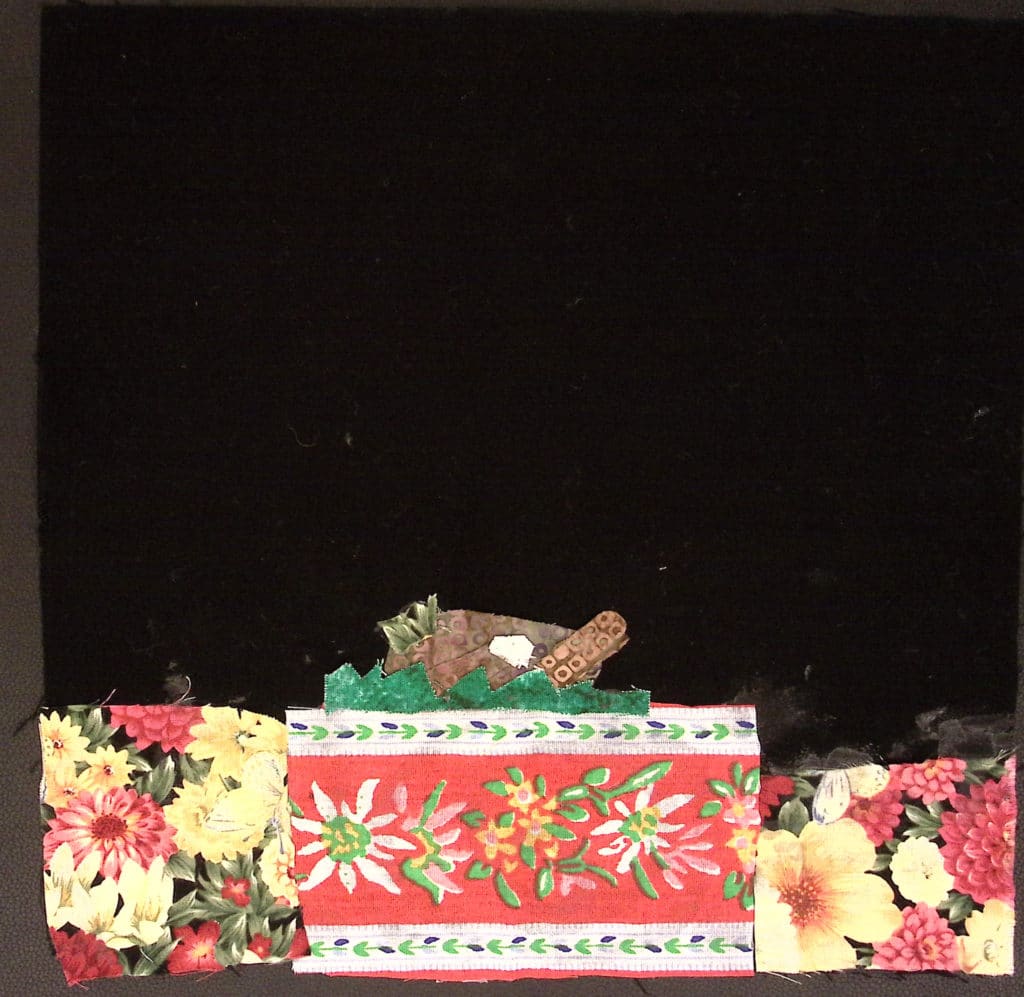 A black square with patterned fabric at the bottom to look like a tablecloth and Thanksgiving turkey.
