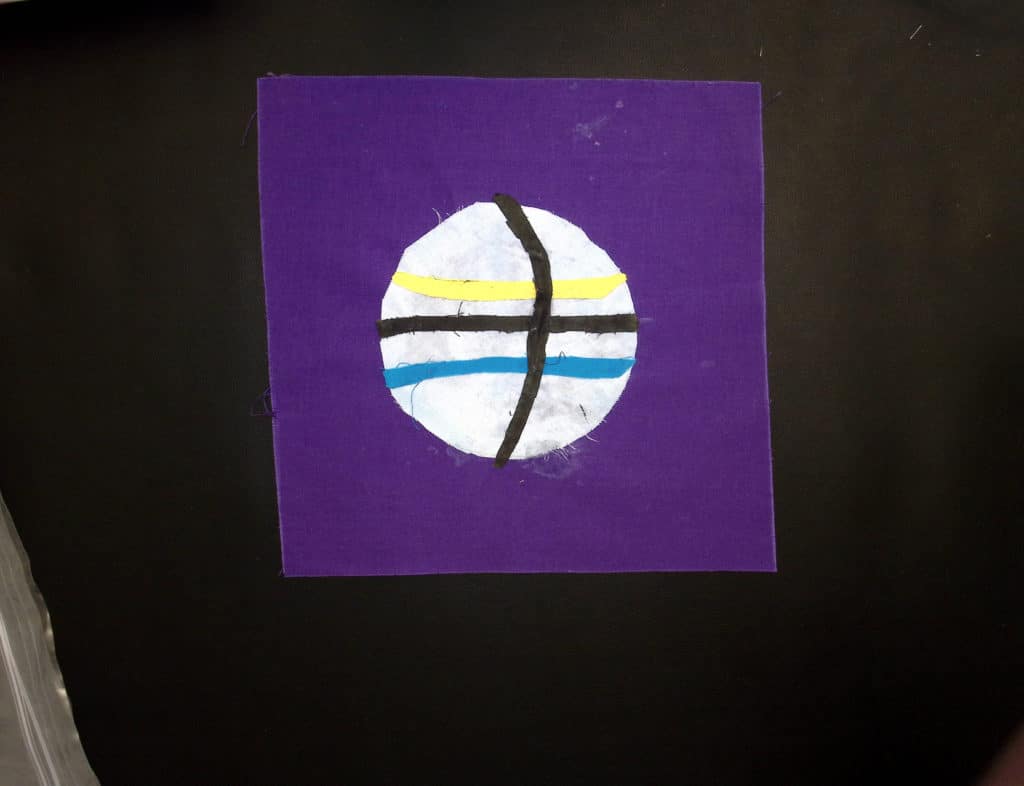 A basketball with yellow, blue and black stripes on a purple background
