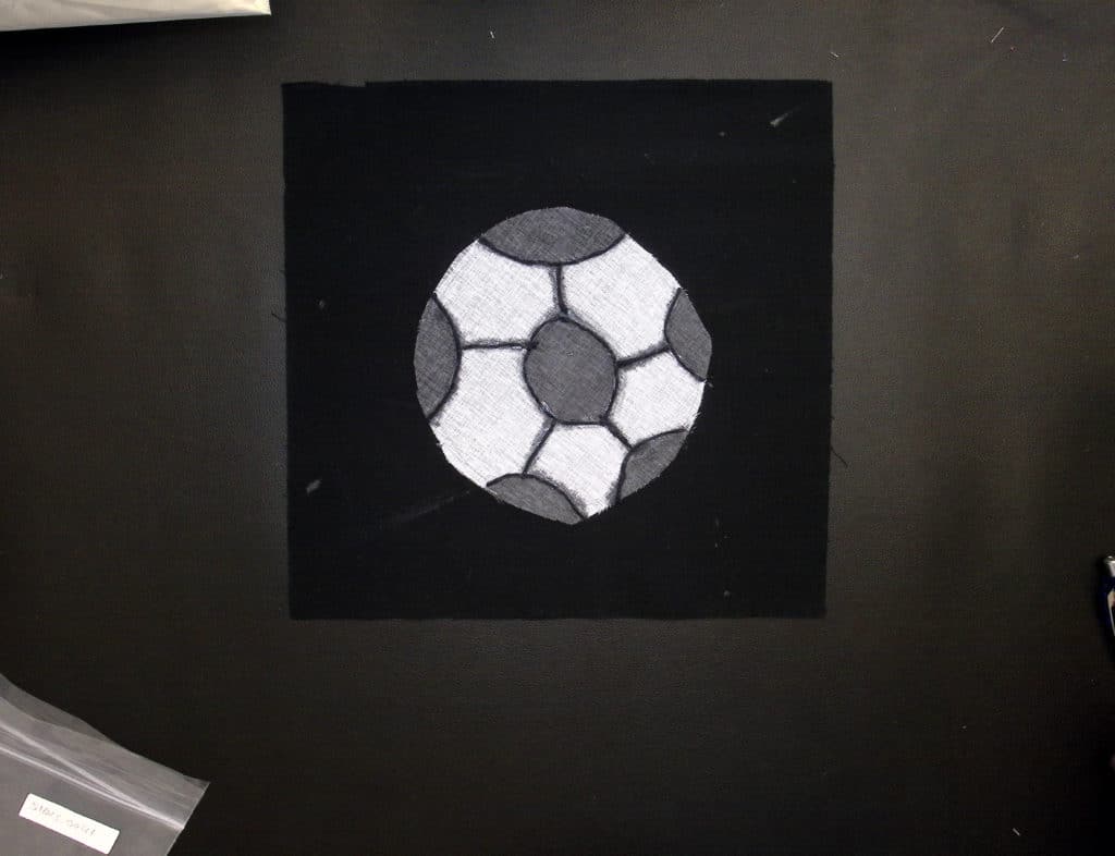 Black and white soccer ball on a black background