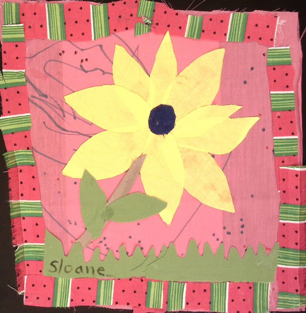 A yellow flower in the middle of a pink background with watermelon striped border
