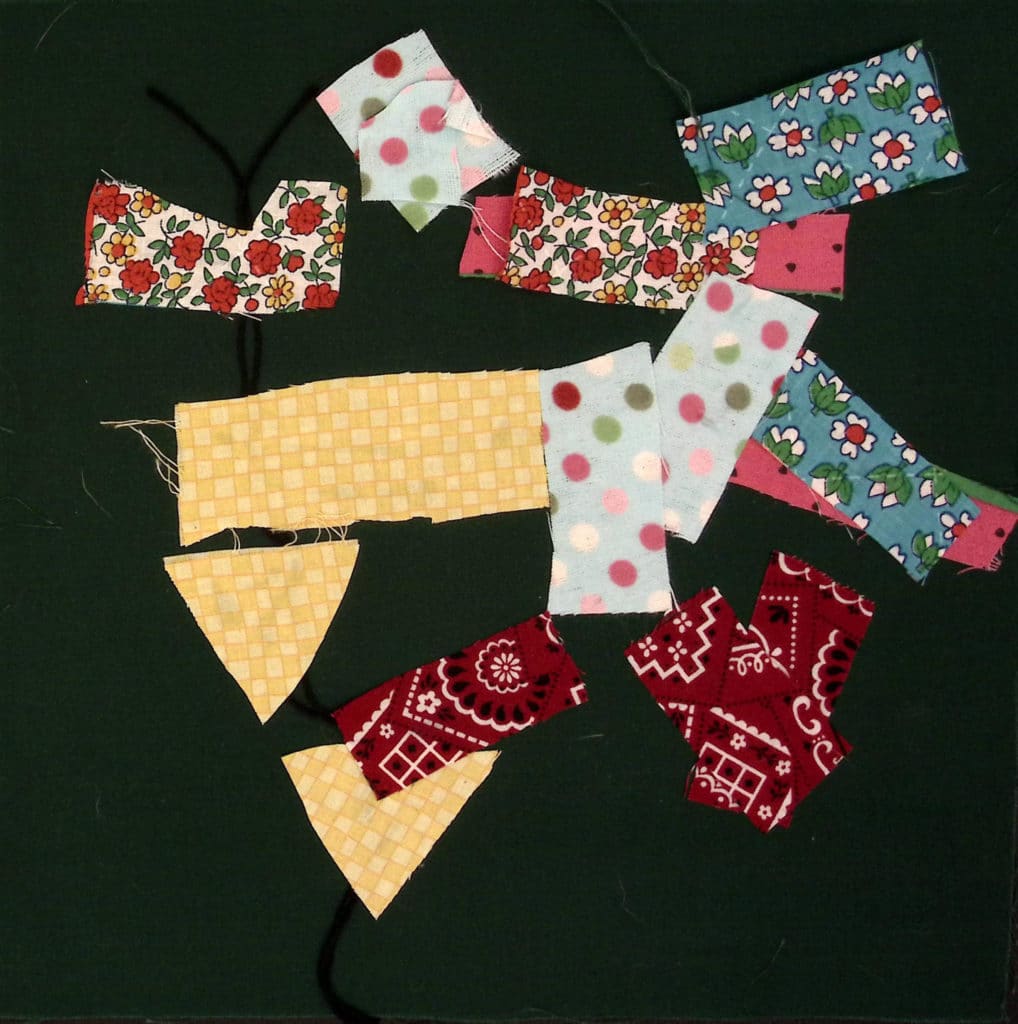 Green background, rectangles made with yellow, red, and flower-print fabric.