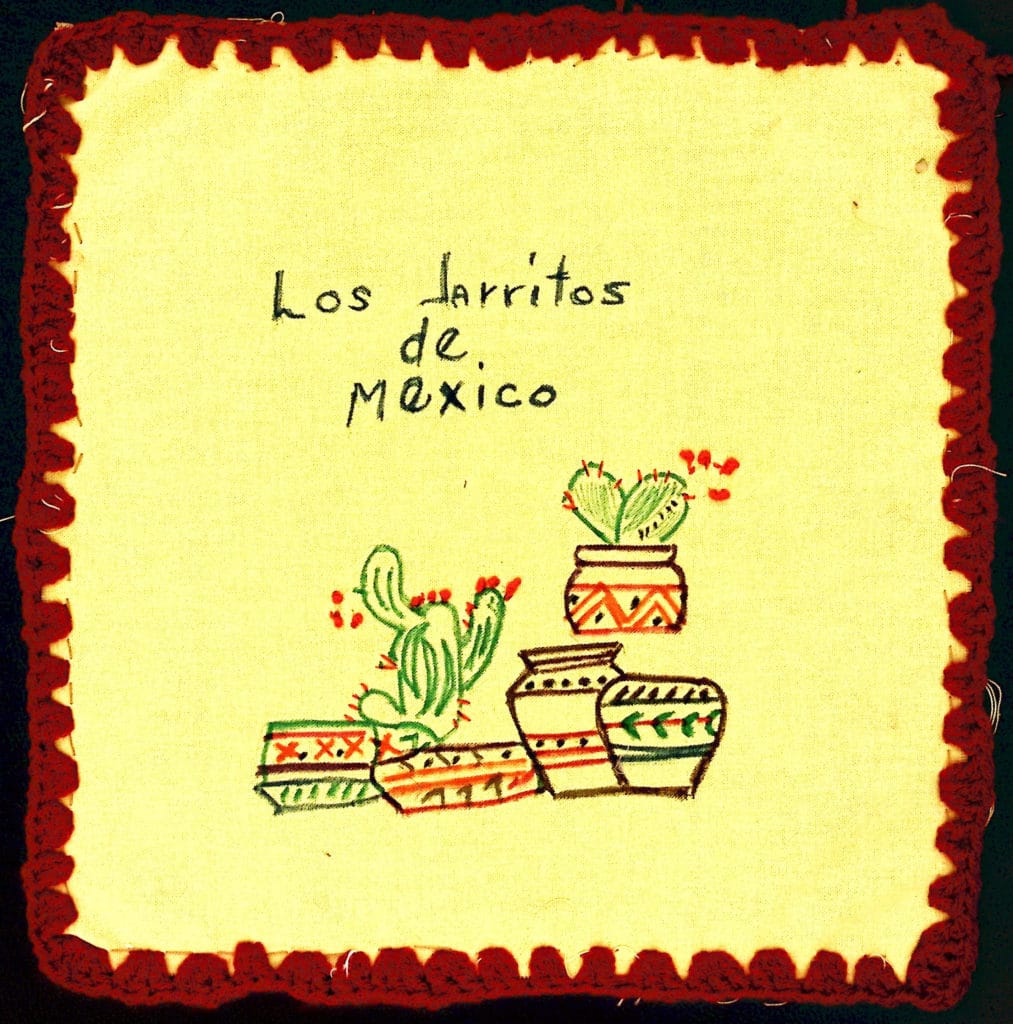 Embroidered cactus and pottery with words "Los jarritos de Mexico."
