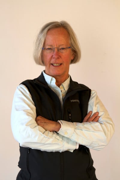 Photo of Cathy Corison wearing a white shirt and black vest.