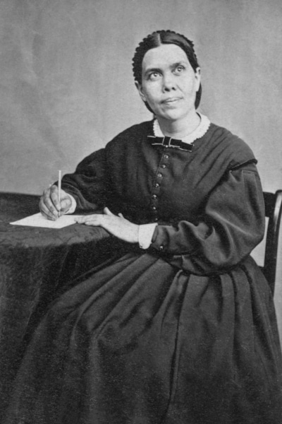 Portrait of Ellen Gould White writing at a desk.