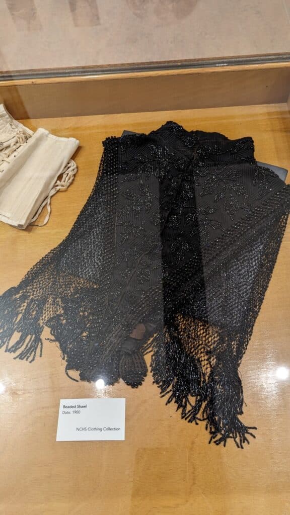 A beaded black cape with lace fringe.