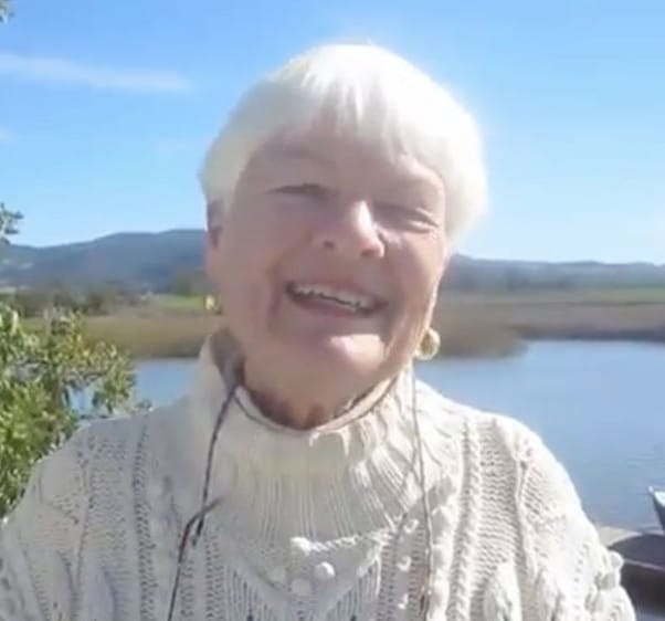 Moira Johnston Block standing in front of a scenic view of the Napa River.