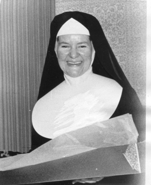 Sister M. Bernadette wearing her nun's habit and holding something in her hands.