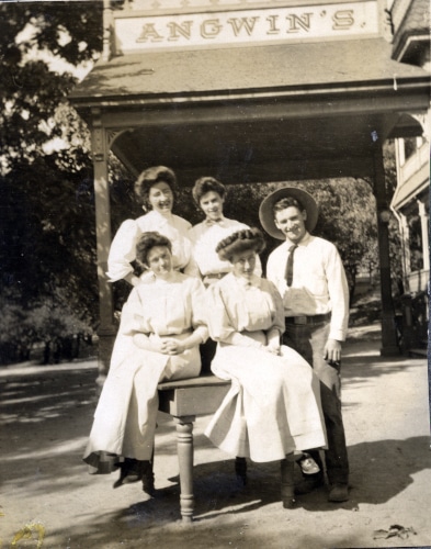 Five young people posing in front of a sign for Angwin's Resort.