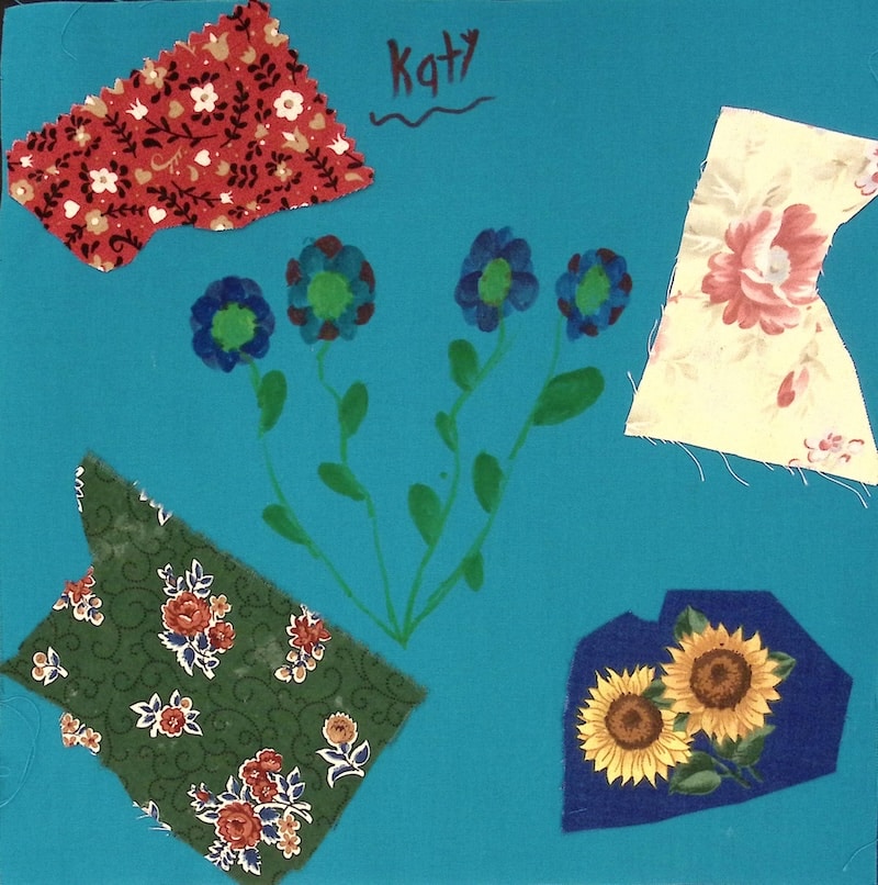 A blue square with flowers and blocks of patterned fabric.