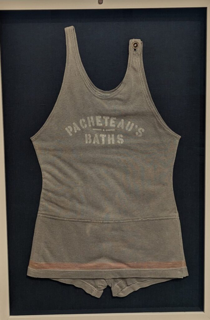 A gray late 1920s or 1930s bathing suit with Pacheteau's Baths printed on the front. Courtesy of Indian Springs Resort.