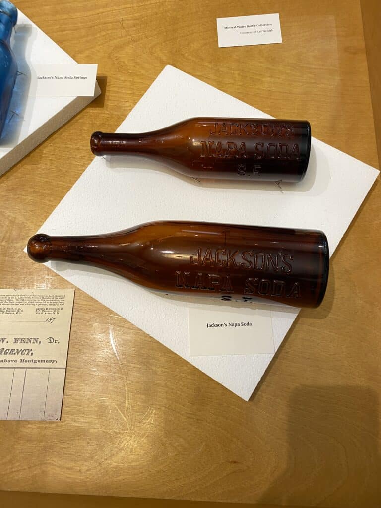 Two brown glass bottles from Jackson's Napa Soda, size suited to restaurants.