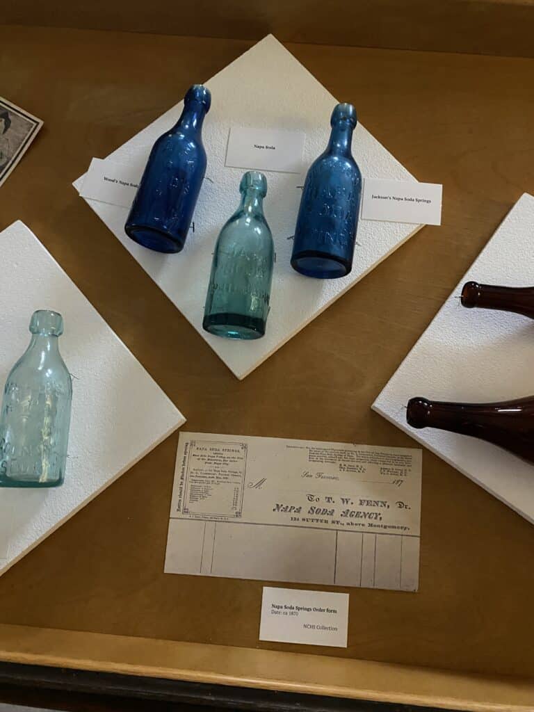 Three blue glass bottles, one in light blue and two in cobalt.