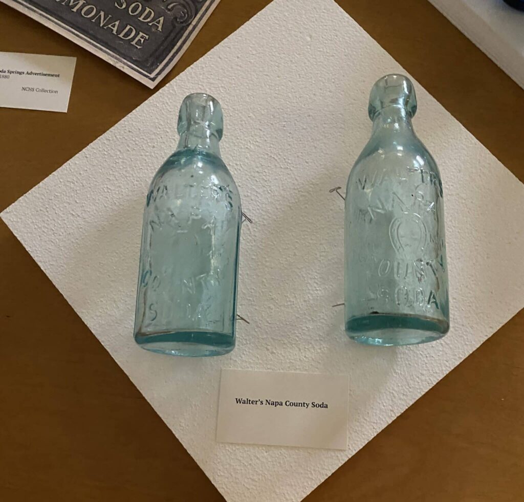 Two light blue glass bottles from Walter's Napa Soda