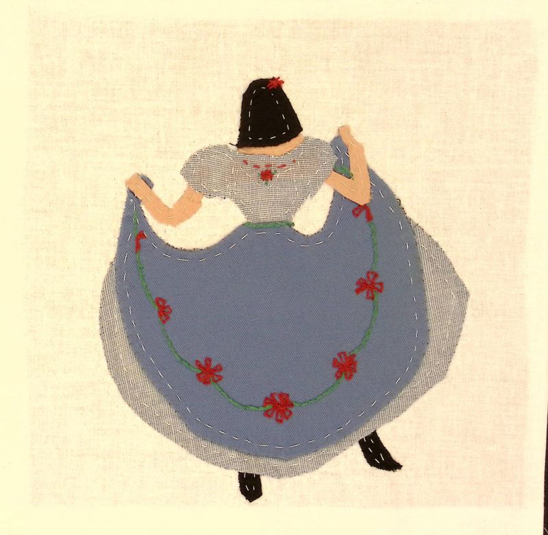 A woman in a blue dress dancing.