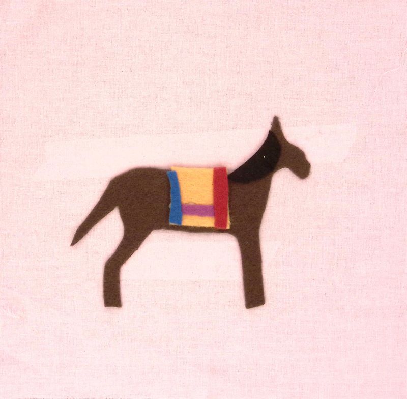 A pink square with a brown horse made of felt.